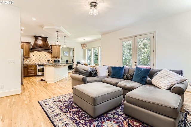 13902 SW Andrew Ter, Portland, OR 97224 - living room with light wood-style flooring and french doors