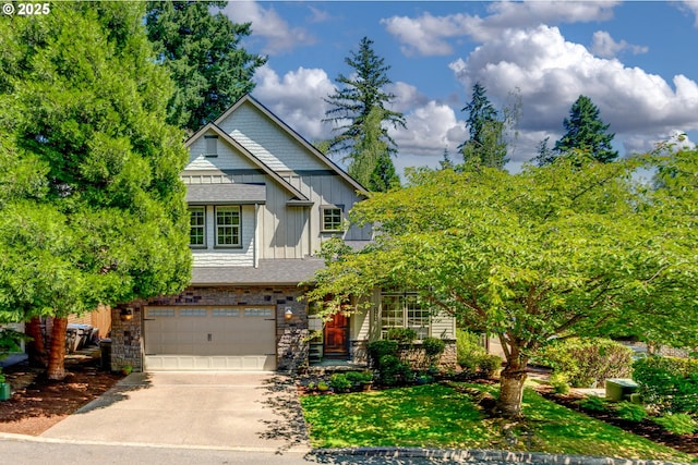 13902 SW Andrew Ter, Portland, OR 97224 - craftsman-style house with board and batten siding, driveway, an attached garage, and stone siding