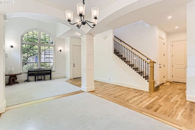 13902 SW Andrew Ter, Portland, OR 97224 - foyer entrance with arched walkways, wood finished floors, a chandelier, decorative columns, and recessed lighting