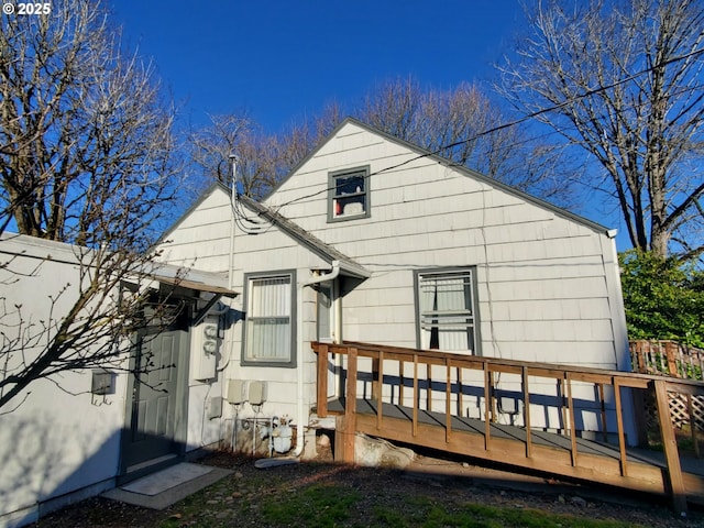 rear view of property featuring a deck