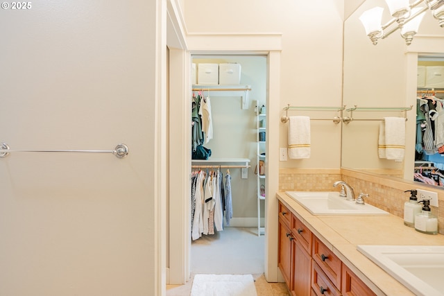 5227 SW Shattuck Rd, Portland, OR 97221 - bathroom featuring decorative backsplash, a spacious closet, and double vanity