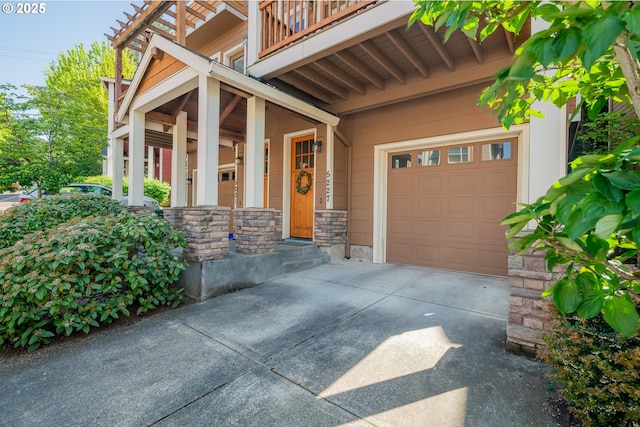 5227 SW Shattuck Rd, Portland, OR 97221 - entrance to property featuring driveway, stone siding, an attached garage, a balcony, and covered porch