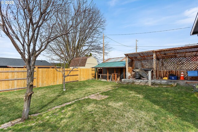 view of yard featuring an outbuilding and a fenced backyard