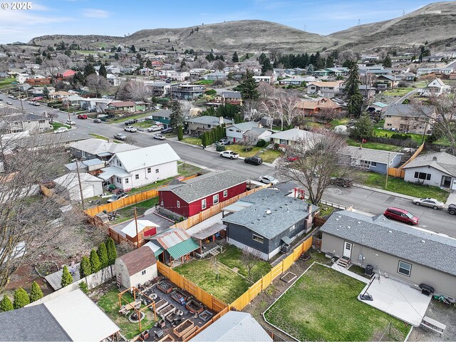 birds eye view of property with a mountain view and a residential view