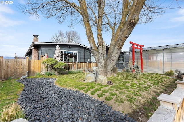 view of yard with an outbuilding, a deck, and fence