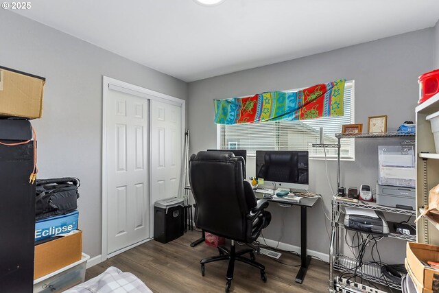 office space with baseboards and wood finished floors