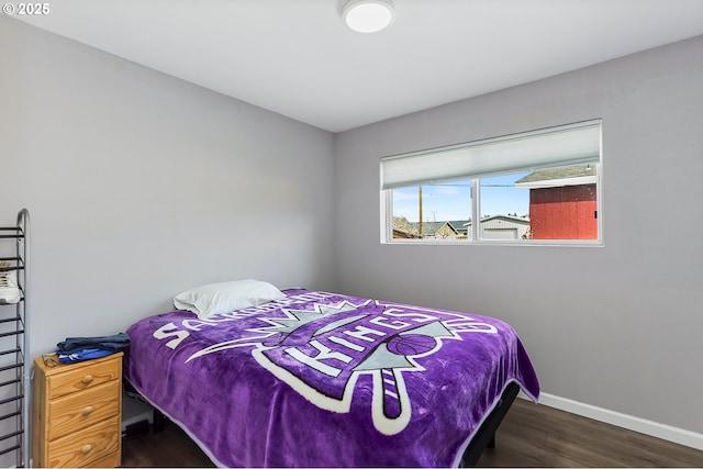 bedroom featuring wood finished floors and baseboards