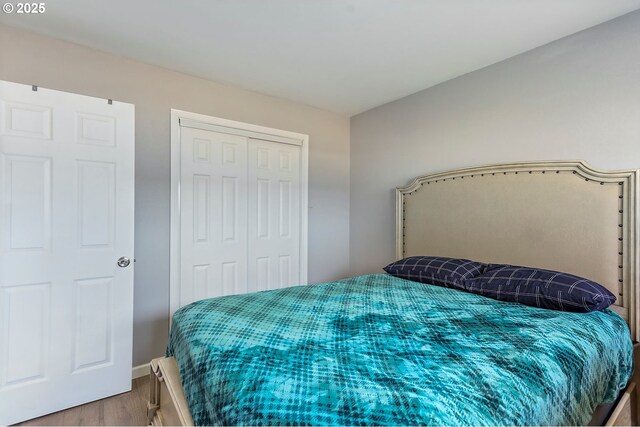 bedroom with a closet and wood finished floors