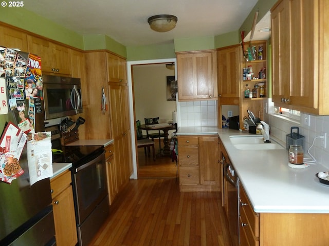 22225 SE Peggy Ann Dr, Damascus, OR 97089 - kitchen featuring appliances with stainless steel finishes, a sink, wood finished floors, backsplash, and light countertops