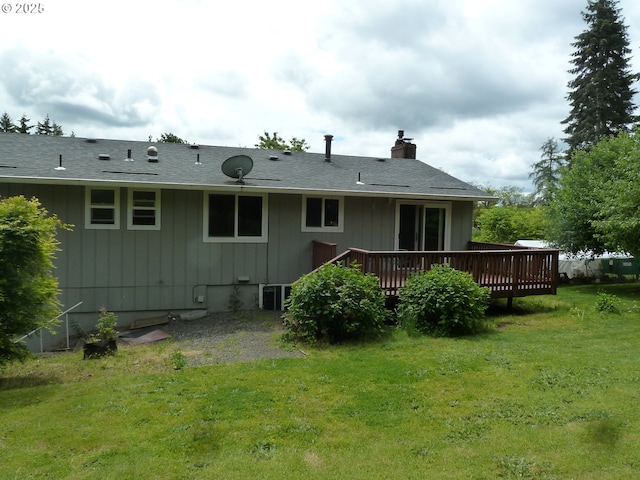 22225 SE Peggy Ann Dr, Damascus, OR 97089 - rear view of house featuring a wooden deck, a yard, a chimney, and central air condition unit