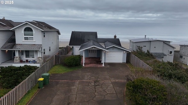 traditional-style house featuring driveway and a fenced front yard