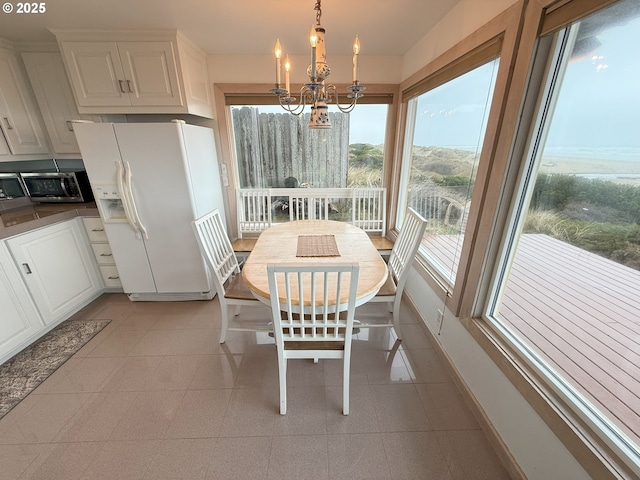 dining room featuring an inviting chandelier and a toaster