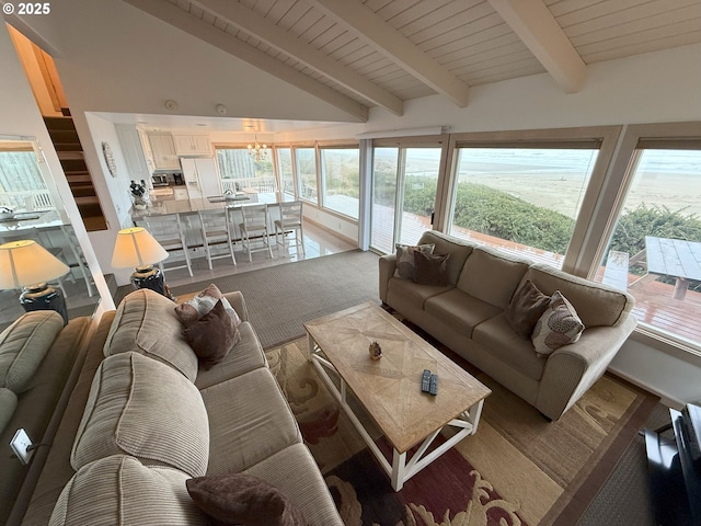 living room featuring wood ceiling, beam ceiling, and a wealth of natural light