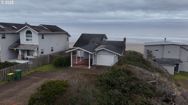 traditional-style house with driveway, a garage, and fence