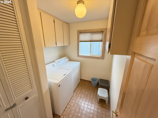 washroom with cabinet space, independent washer and dryer, and light floors