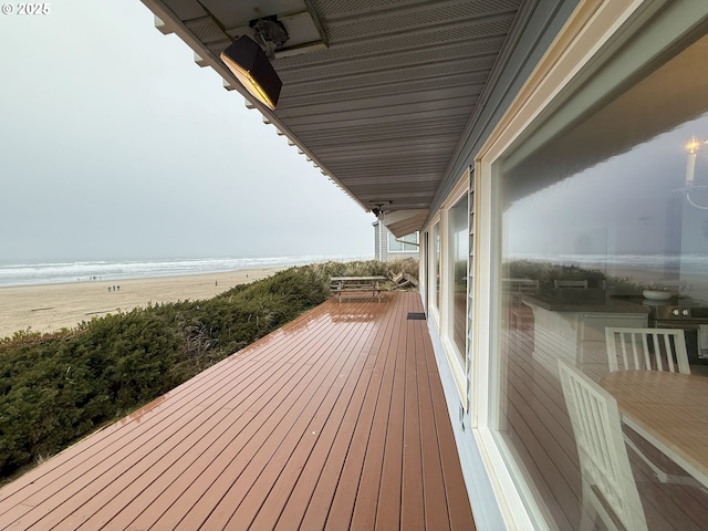 deck with a beach view and a water view