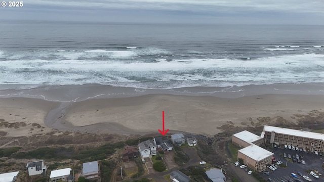 birds eye view of property featuring a view of the beach and a water view