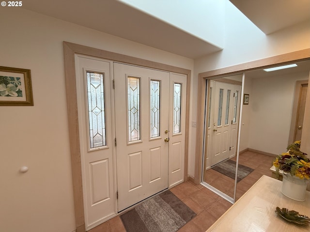 foyer featuring baseboards