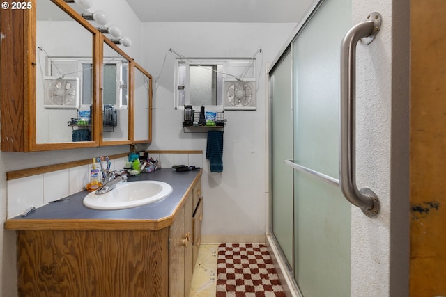 bathroom with vanity and an enclosed shower