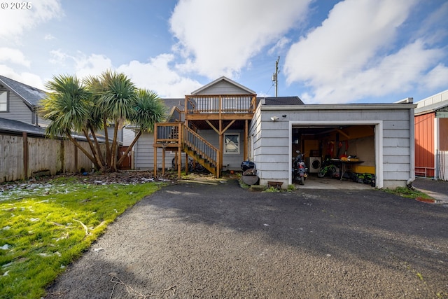 rear view of property featuring a yard and a deck