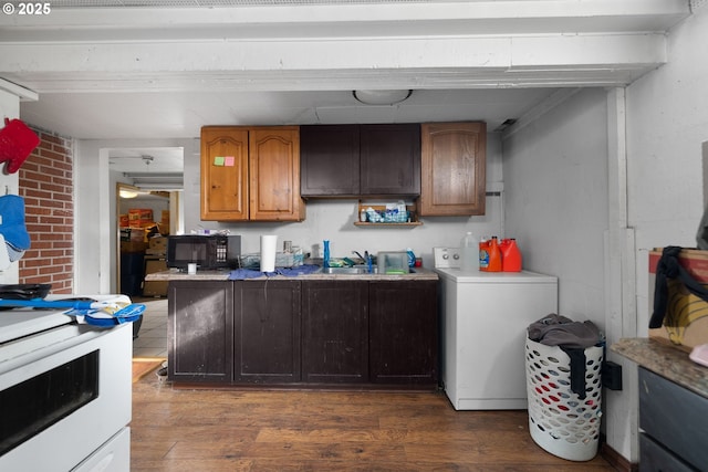 kitchen with washer / dryer, dark hardwood / wood-style floors, sink, and stove