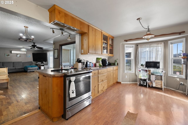 kitchen with hanging light fixtures, electric range, ceiling fan, light brown cabinets, and light wood-type flooring