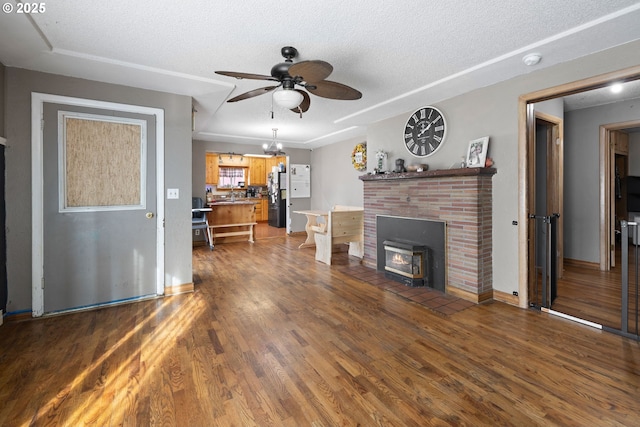 living room featuring dark hardwood / wood-style floors, sink, a textured ceiling, and ceiling fan