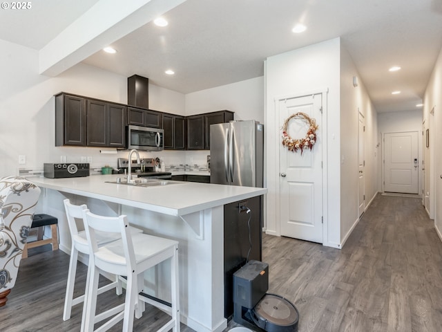 1939 NE 117th Ct, Vancouver, WA 98684 - kitchen featuring a breakfast bar, appliances with stainless steel finishes, and wood finished floors