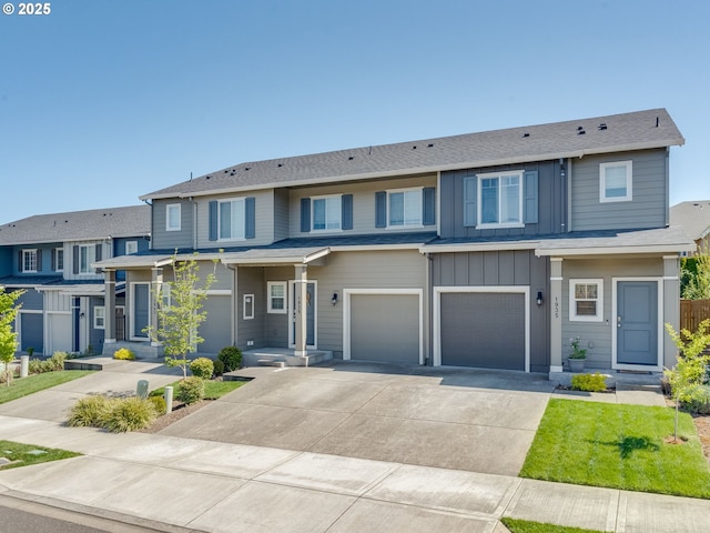 1939 NE 117th Ct, Vancouver, WA 98684 - townhome / multi-family property with driveway, board and batten siding, and an attached garage