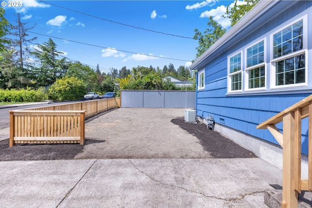 view of patio featuring fence and cooling unit