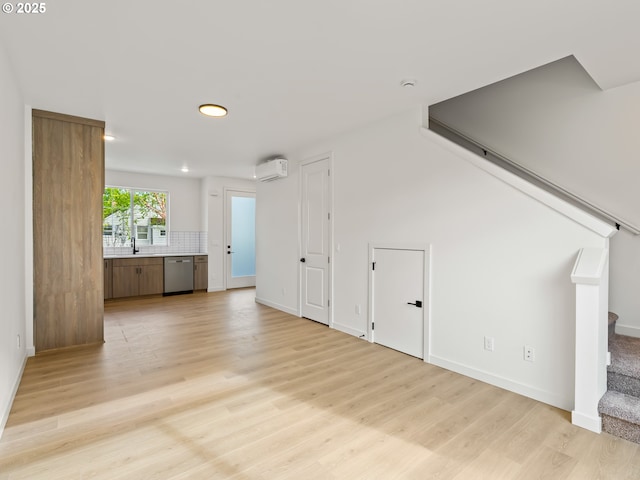 7586 N Alma Ave Unit 2, Portland, OR 97203 - unfurnished living room featuring stairs, a wall unit AC, light wood-style floors, recessed lighting, and baseboards