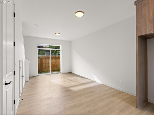 7586 N Alma Ave Unit 2, Portland, OR 97203 - unfurnished bedroom featuring access to exterior, light wood-type flooring, and baseboards