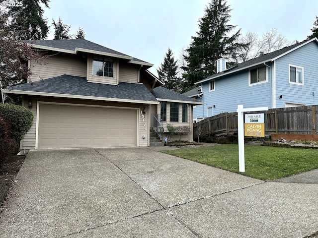 view of front of home with a garage and a front lawn