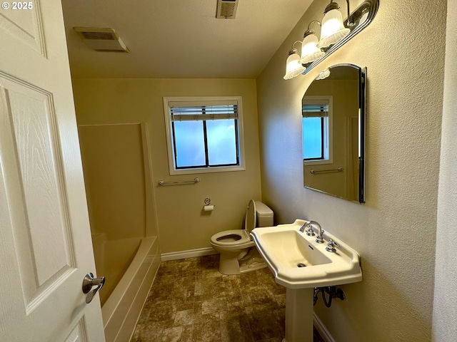 bathroom featuring a bathtub and toilet