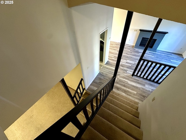 stairs featuring hardwood / wood-style floors