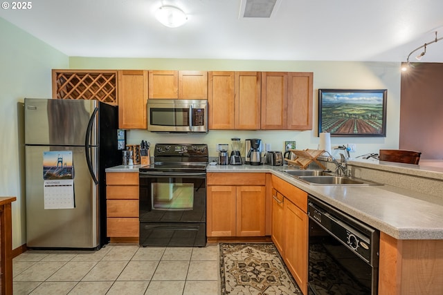 620 NW Naito Pkwy Unit B12, Portland, OR 97209 - kitchen with a peninsula, light countertops, a sink, and black appliances