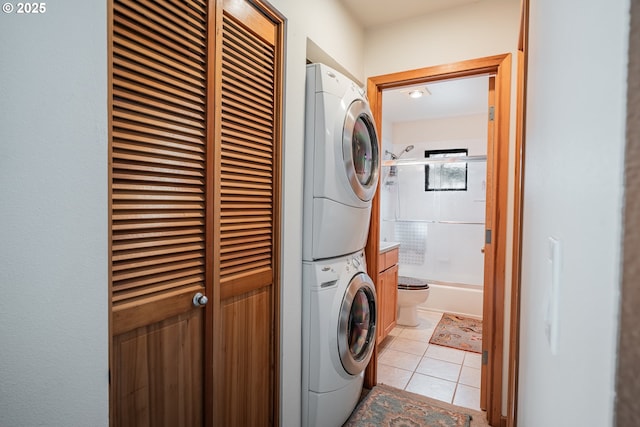 620 NW Naito Pkwy Unit B12, Portland, OR 97209 - laundry area featuring stacked washer and dryer, laundry area, and light tile patterned floors