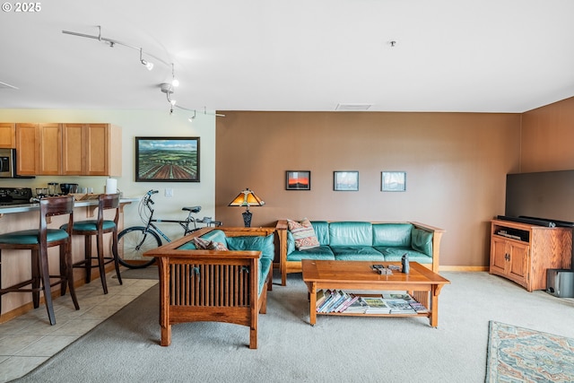 620 NW Naito Pkwy Unit B12, Portland, OR 97209 - living area featuring light carpet, track lighting, visible vents, and baseboards