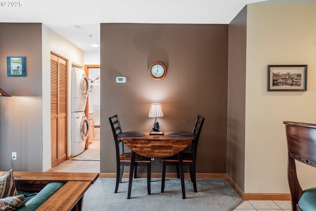 620 NW Naito Pkwy Unit B12, Portland, OR 97209 - dining space featuring baseboards, light tile patterned flooring, and stacked washer and clothes dryer
