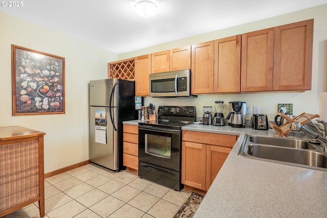 620 NW Naito Pkwy Unit B12, Portland, OR 97209 - kitchen featuring stainless steel appliances, a sink, baseboards, light countertops, and light tile patterned floors