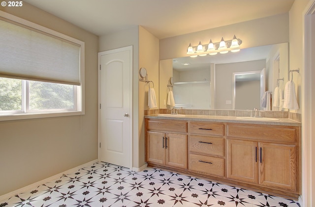 10201 NE 46th Ave, Vancouver, WA 98686 - full bathroom featuring double vanity, baseboards, an enclosed shower, and tile patterned floors
