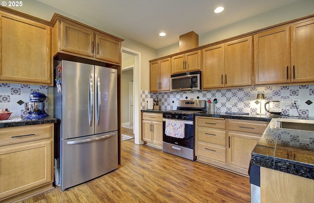 10201 NE 46th Ave, Vancouver, WA 98686 - kitchen with appliances with stainless steel finishes, tile countertops, light wood-type flooring, tasteful backsplash, and recessed lighting