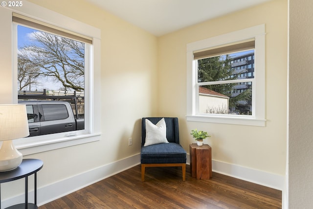 living area featuring wood finished floors and baseboards