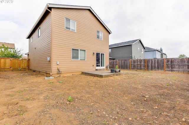 rear view of house featuring a patio and a fenced backyard