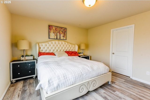 bedroom featuring wood finished floors and baseboards