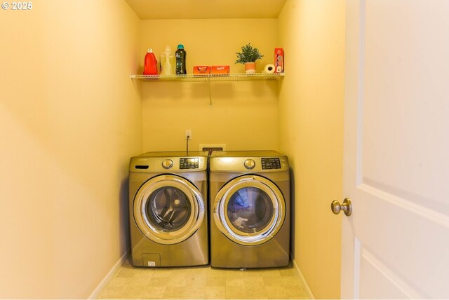 laundry area featuring washer and clothes dryer, baseboards, and laundry area
