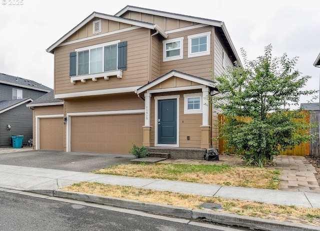 view of front of house with an attached garage, driveway, and board and batten siding