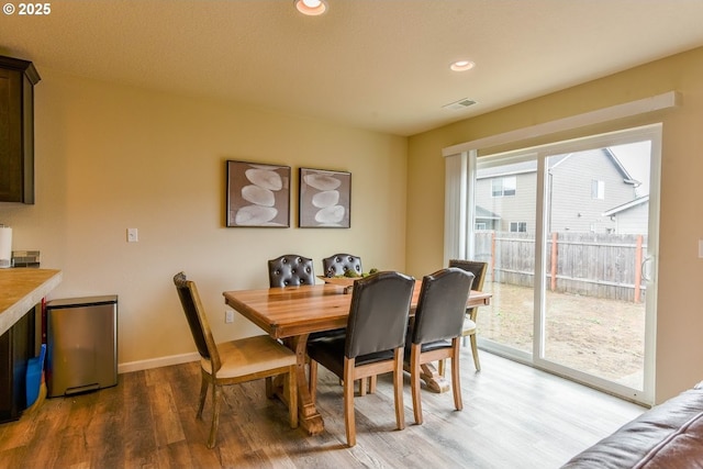 dining area featuring baseboards, recessed lighting, visible vents, and light wood-type flooring