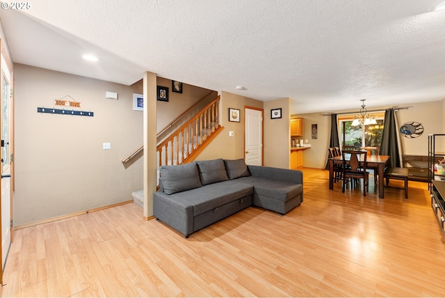 3929 SE 117th Pl, Portland, OR 97266 - living area with light wood finished floors, a textured ceiling, stairs, a chandelier, and recessed lighting