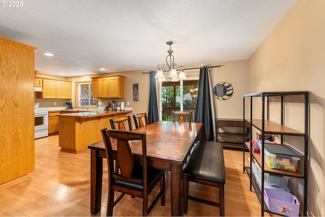 3929 SE 117th Pl, Portland, OR 97266 - dining area featuring a chandelier, light wood-style flooring, plenty of natural light, a textured ceiling, and recessed lighting